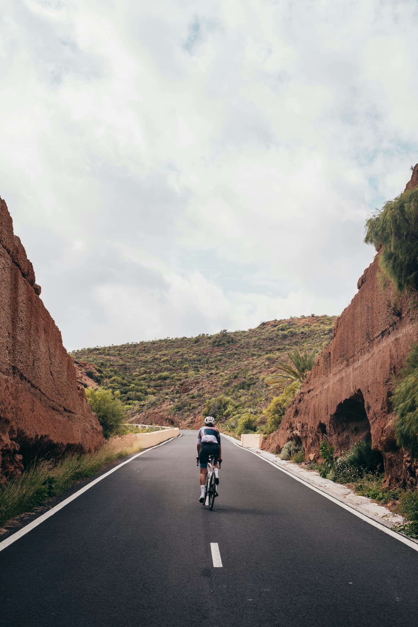 Cyclist riding an open mountain road